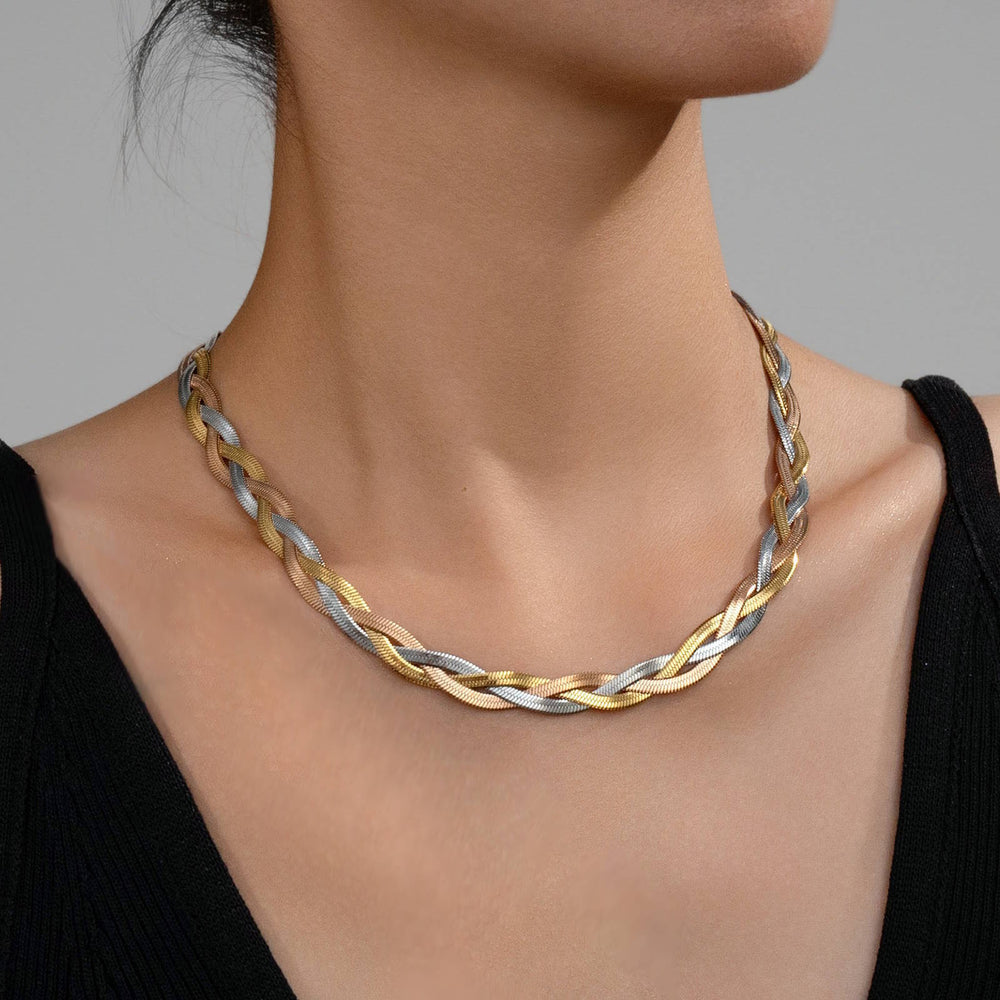 Tri-color braided necklace on a model against a neutral background