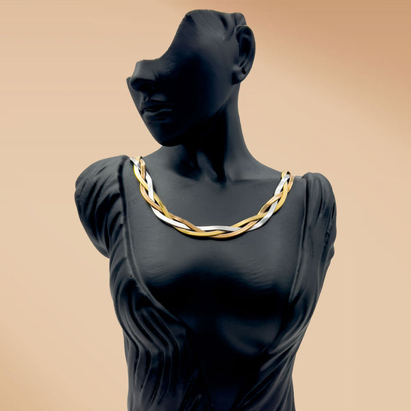 Mannequin wearing a gold and silver necklace on a beige background