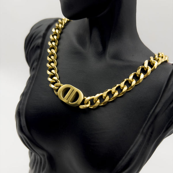 Gold chain necklace on a black mannequin bust