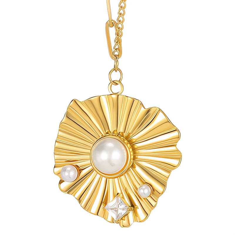 Gold pendant with pearl and crystal on a white background